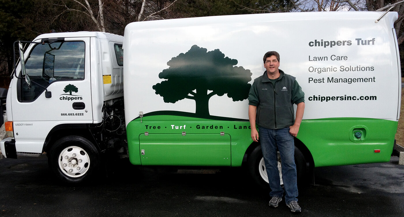 Mr Grass standing next to a Chippers Turf division truck.